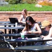 Students studying outside of the UMC on campus