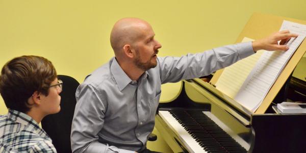 College of Music professor Daniel Kellogg works with a student in his office