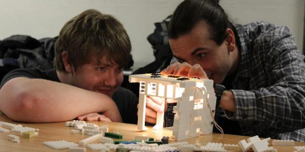 Two students work on a Lego lighting project during their architectural lighting design class